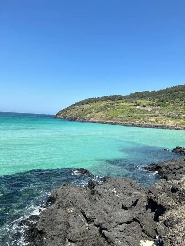 Emerald turquoise bay and basalt rocks on the Jeju coast