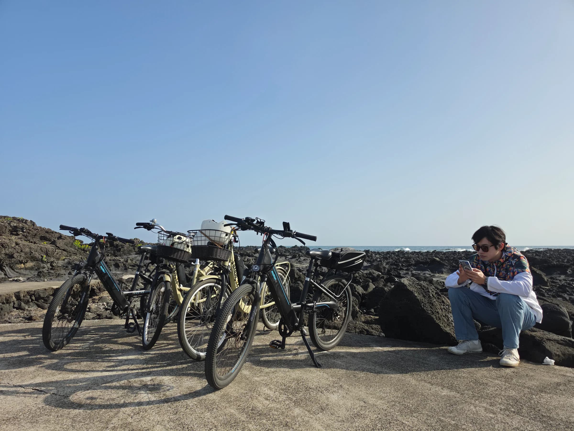Bicycles parked along the rocky shoreline