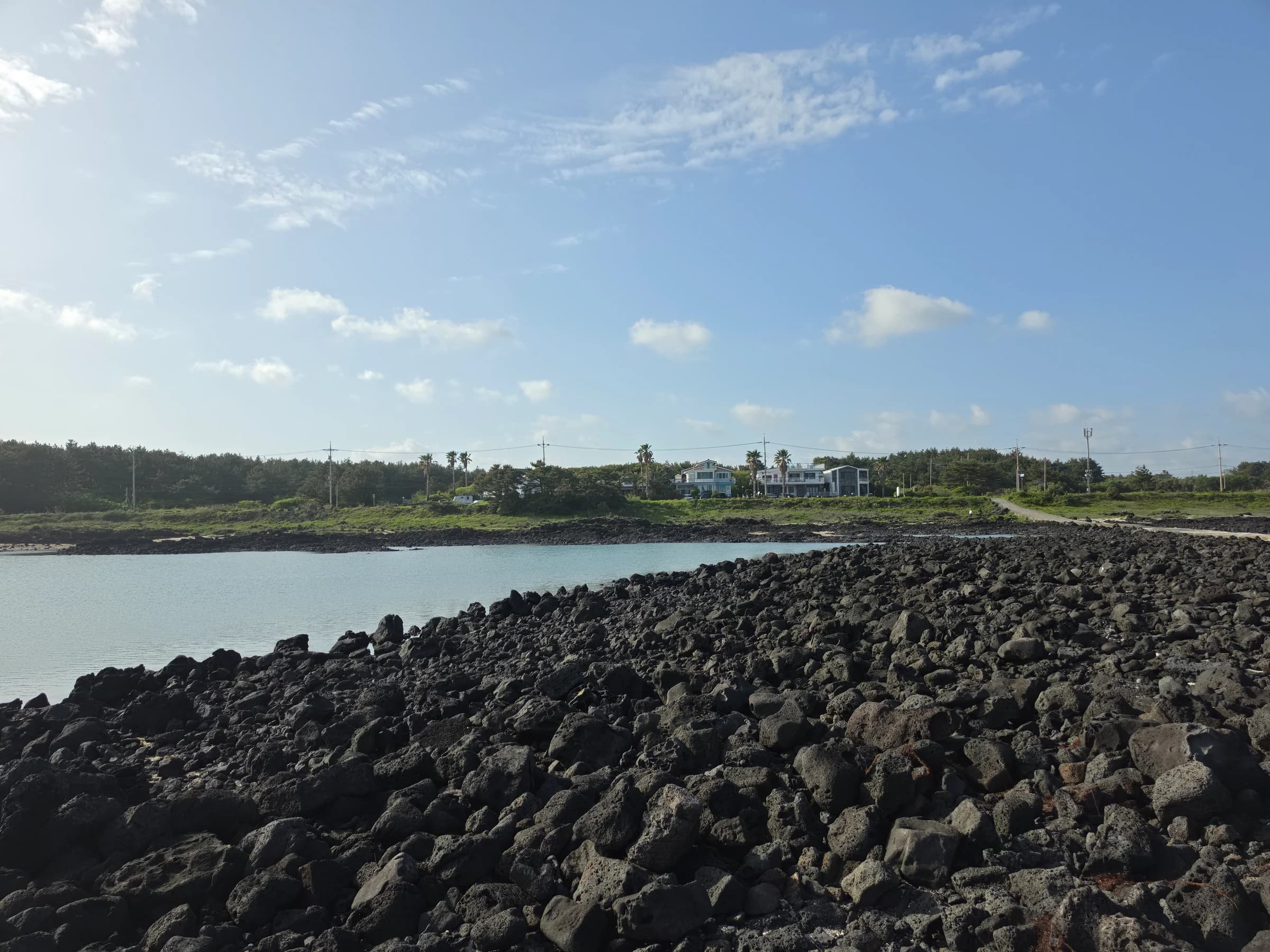 Coastal village across a basalt-rock cove