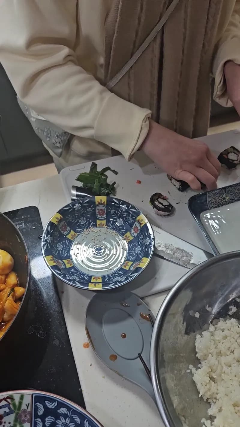 Slicing finished kimbap rolls on the cutting board