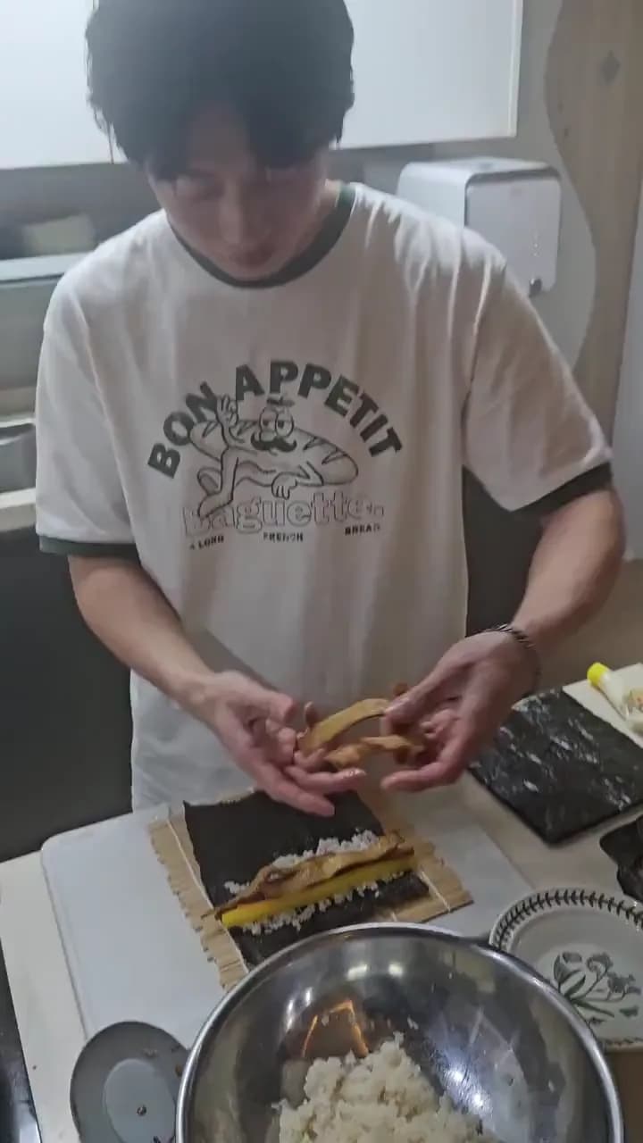 Rolling kimbap on a bamboo mat