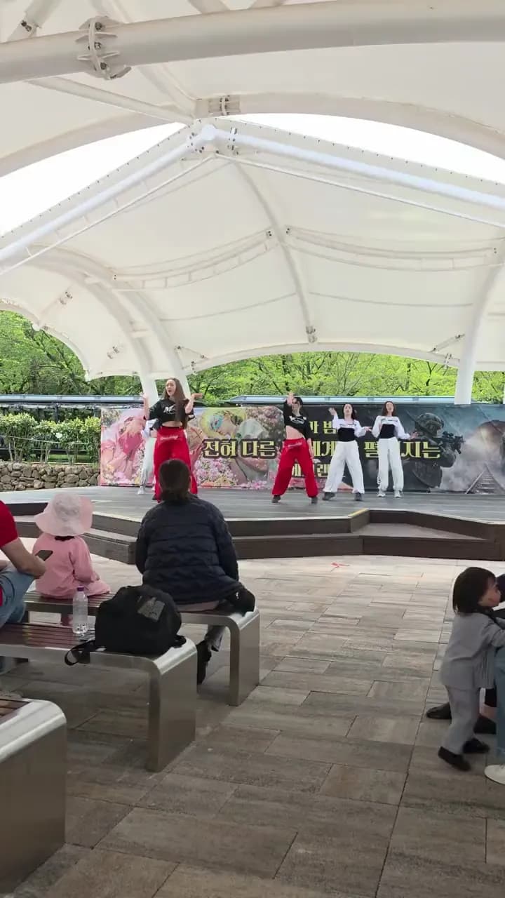 K-pop dance performance at an outdoor stage