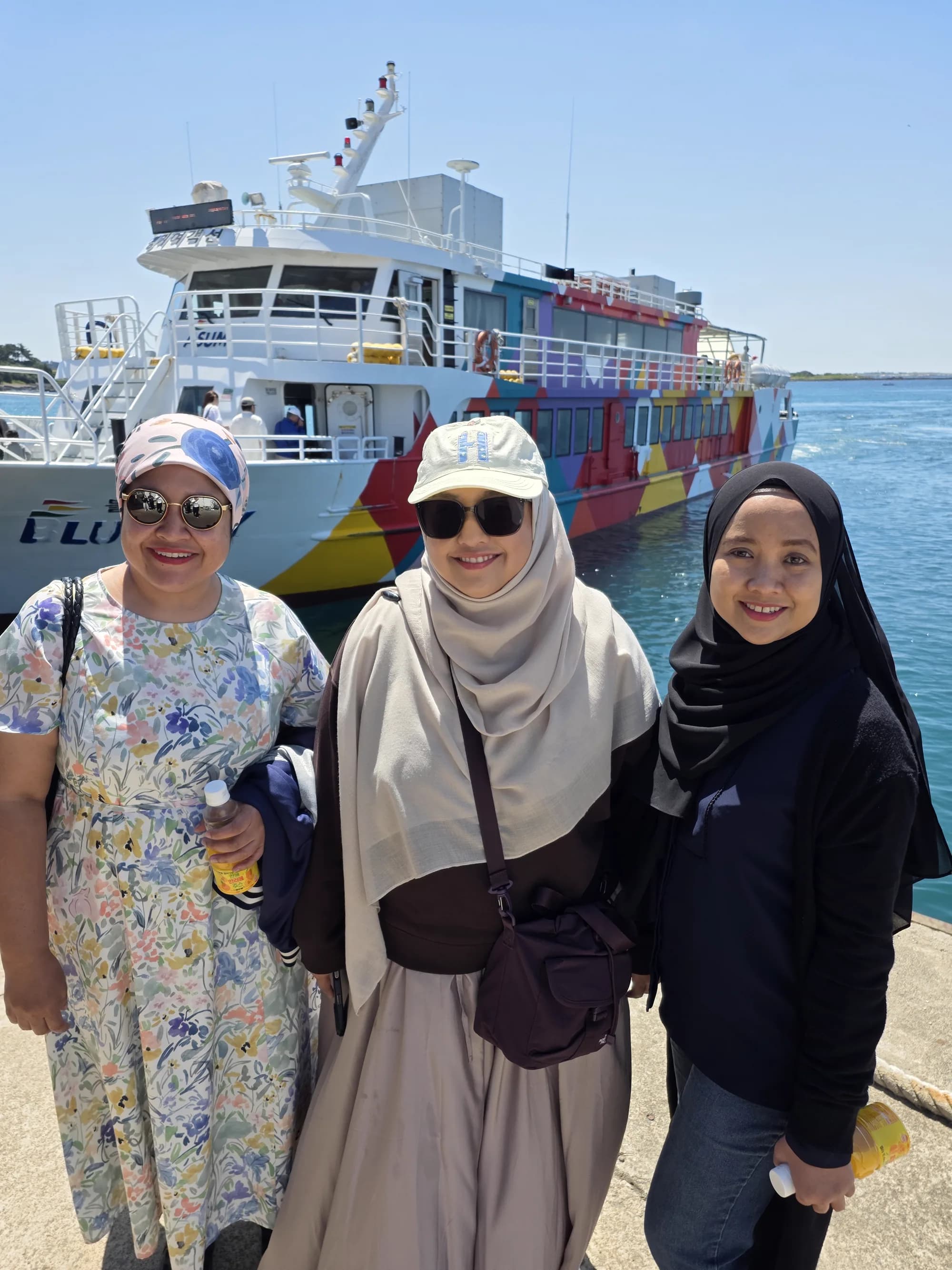 Selfie on the Gapado ferry — colorful boat in the background