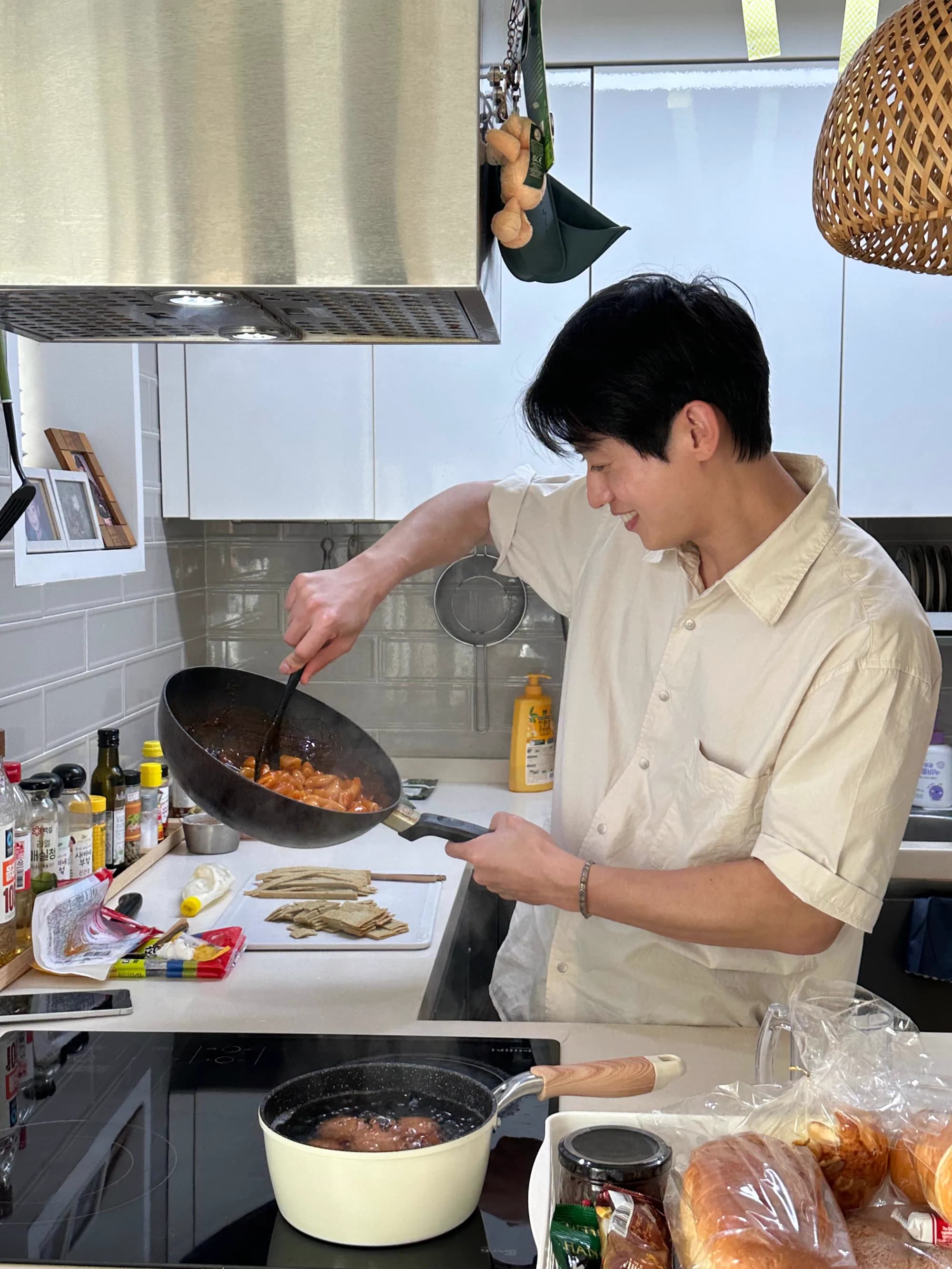 Nasir cooking dinner at the villa kitchen — pan, side dishes, fresh bread