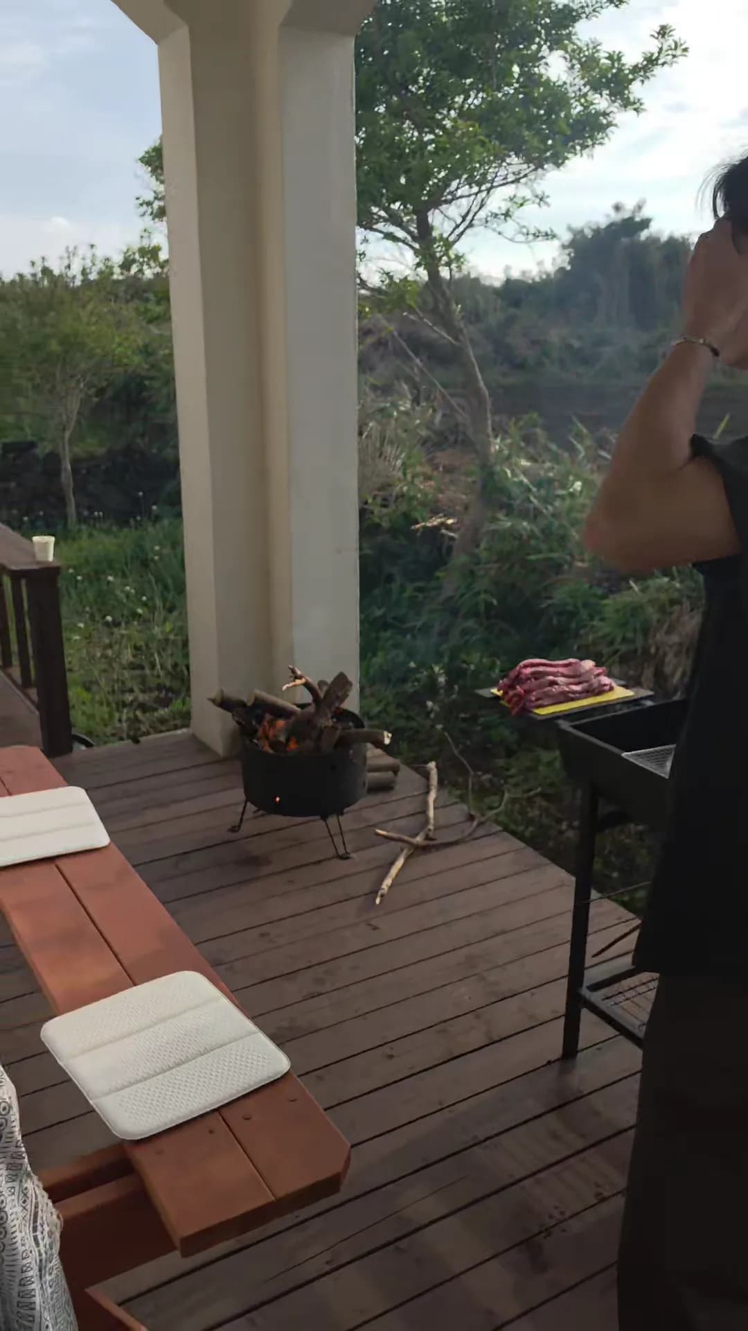 Setting up the farewell BBQ on the villa terrace — fire pit, grill, fresh meat