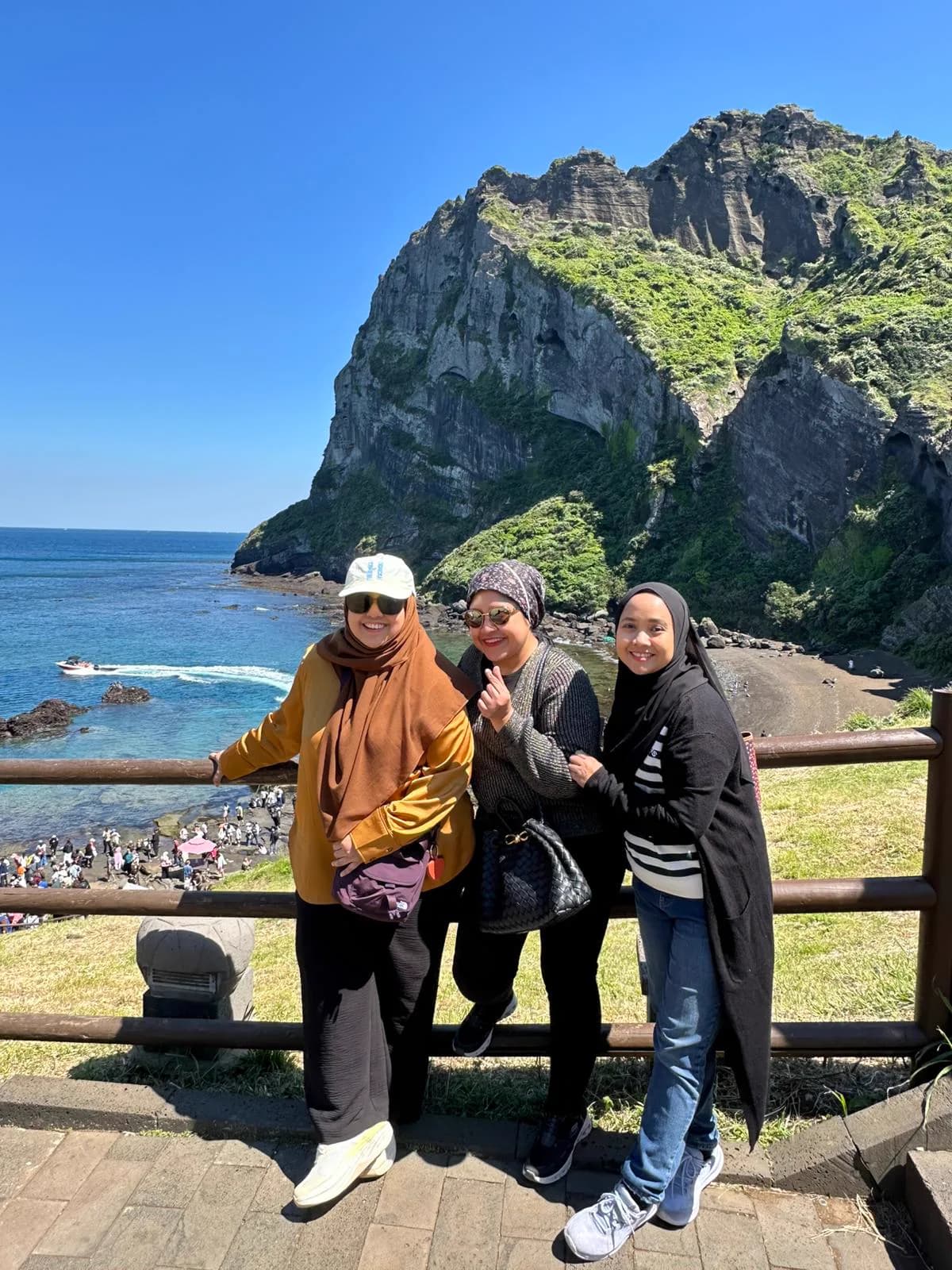 Guests at the Seongsan Ilchulbong viewpoint with the volcanic peak behind