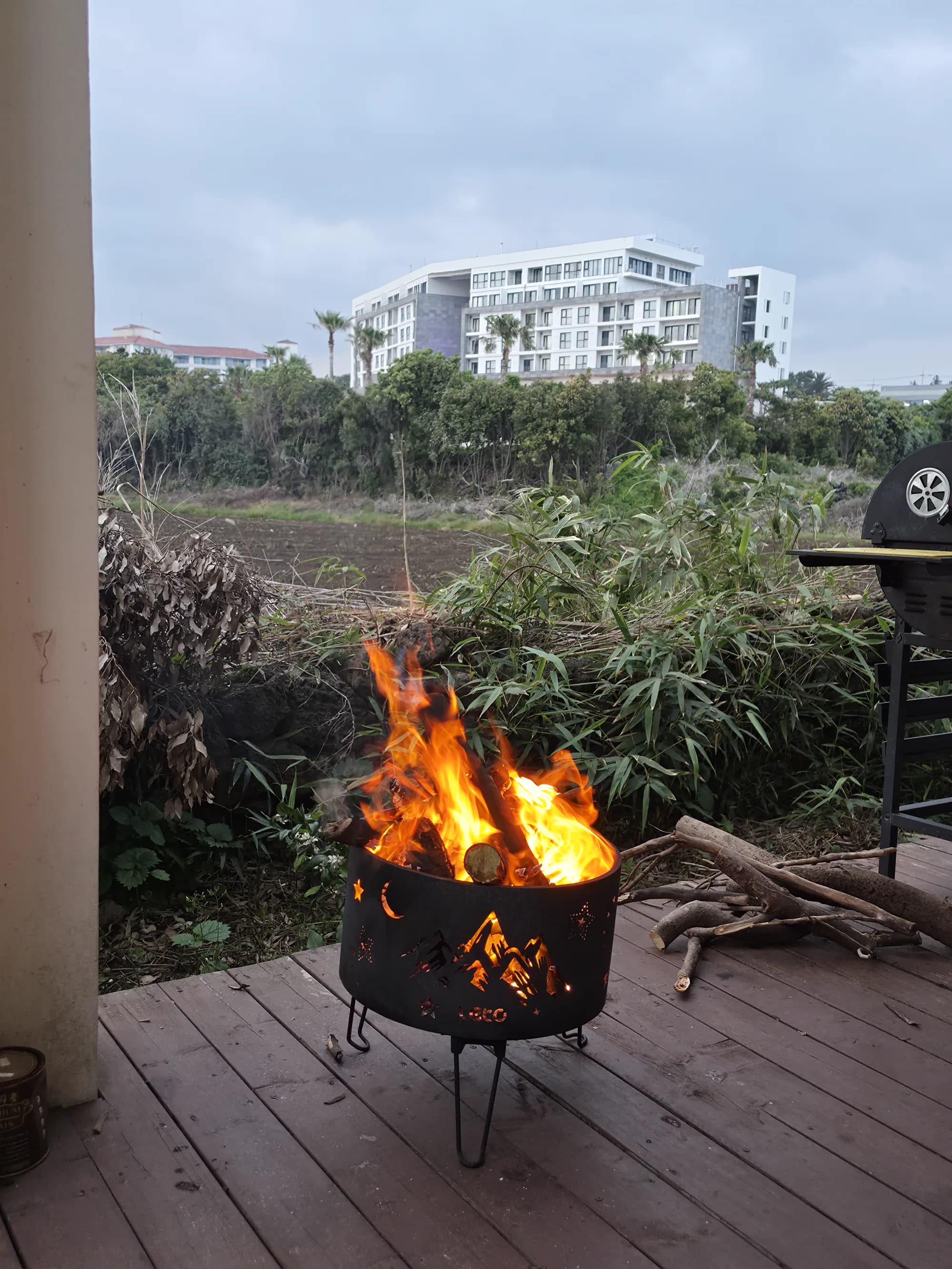 Wood-burning fire pit on the villa terrace at dusk