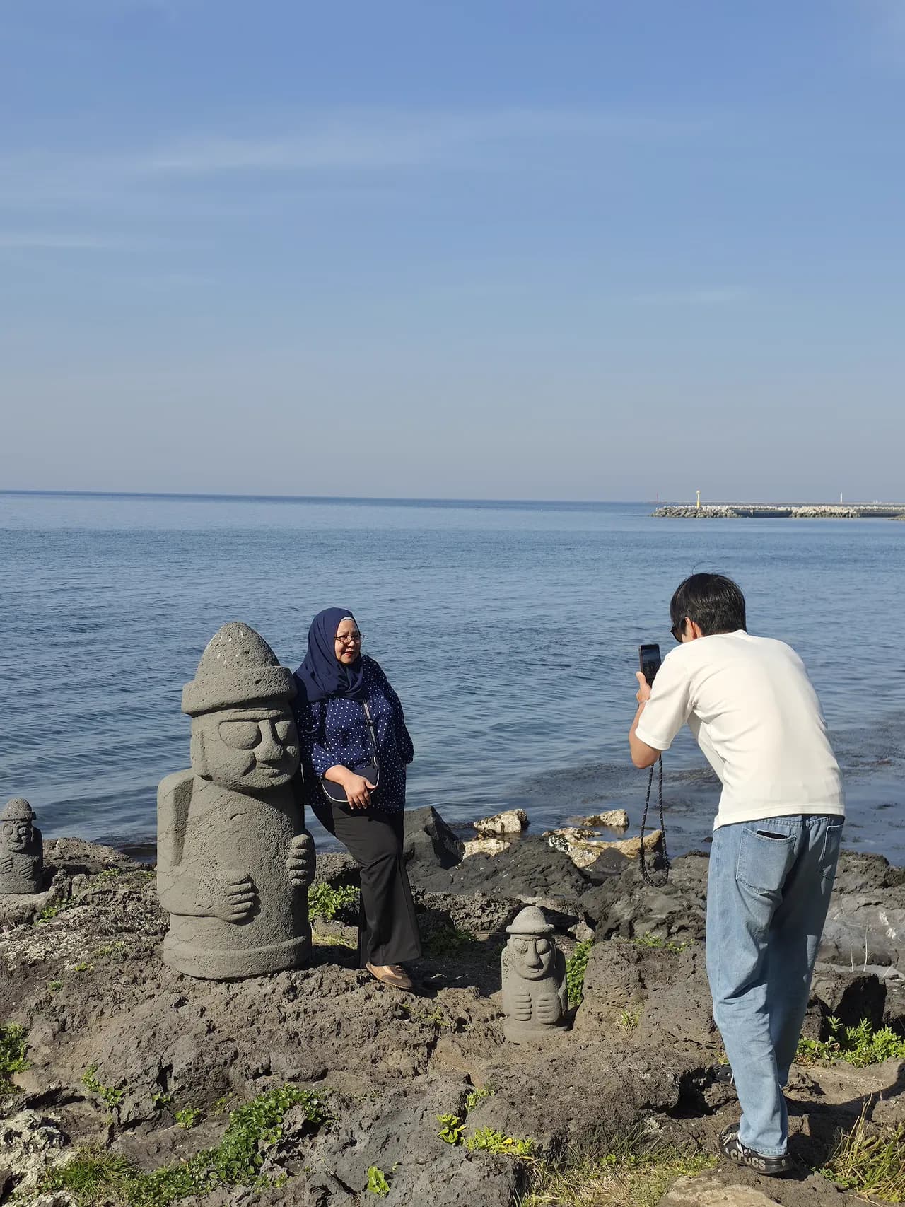 Stacking stone cairns on the basalt tidal flats by the sea
