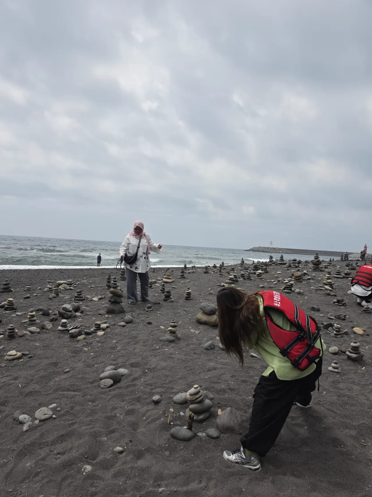 Exploring the black-rock tidal flats at low tide on the Seongsan coast