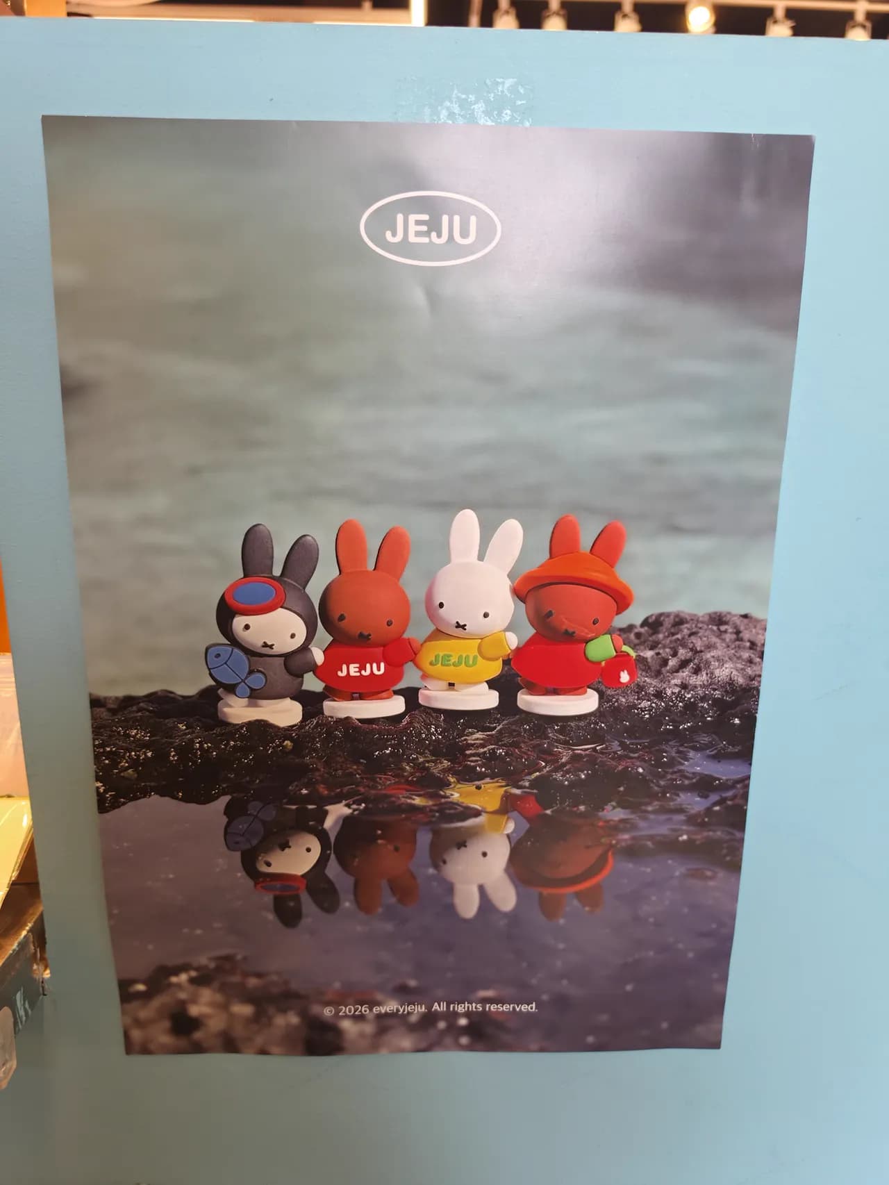 A Jeju × Miffy souvenir print at a seaside gift shop