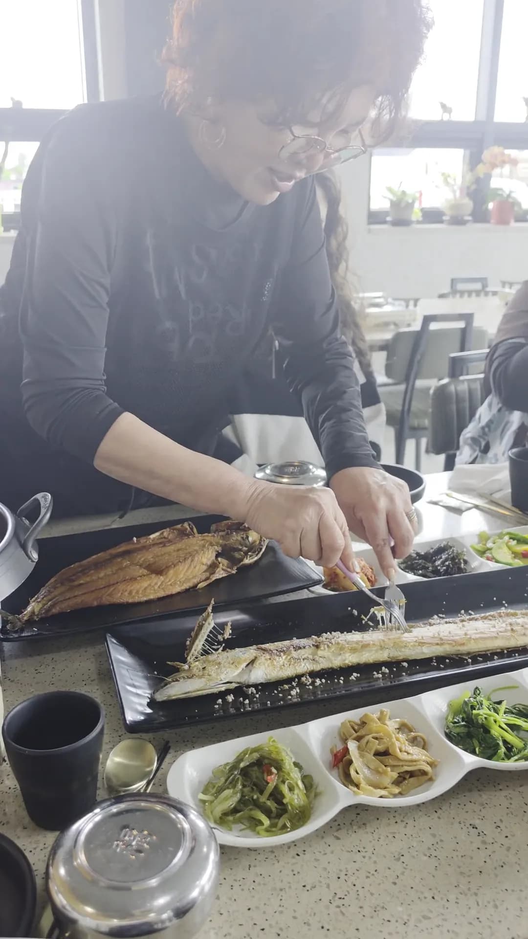 A Korean grilled-fish dinner with banchan side dishes