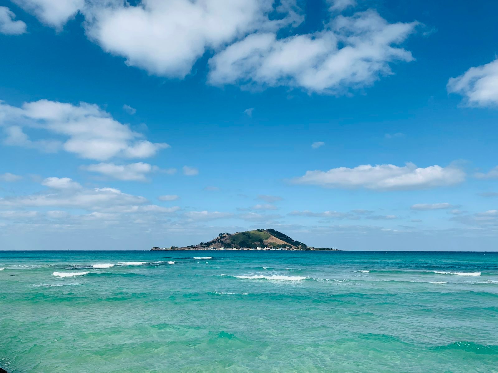 Biyangdo island floating in the emerald shallows off Hyeopjae Beach, west Jeju